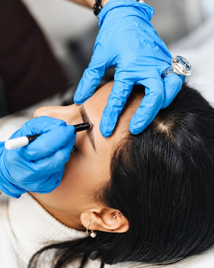 Microblading hair strokes being applied
